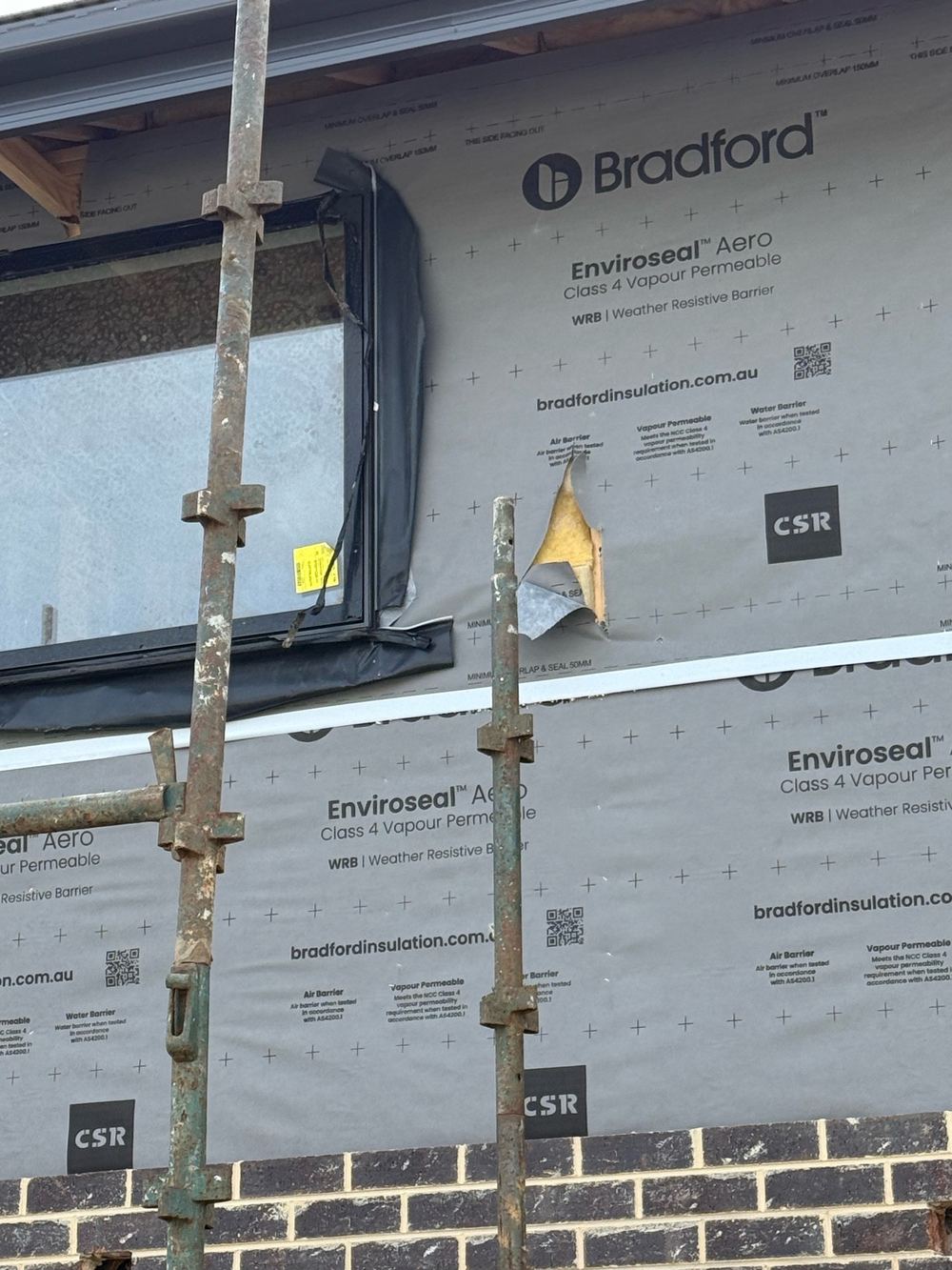 Building wrap torn in several places before the cladding closed it in, found during a lock-up inspection in Berwick