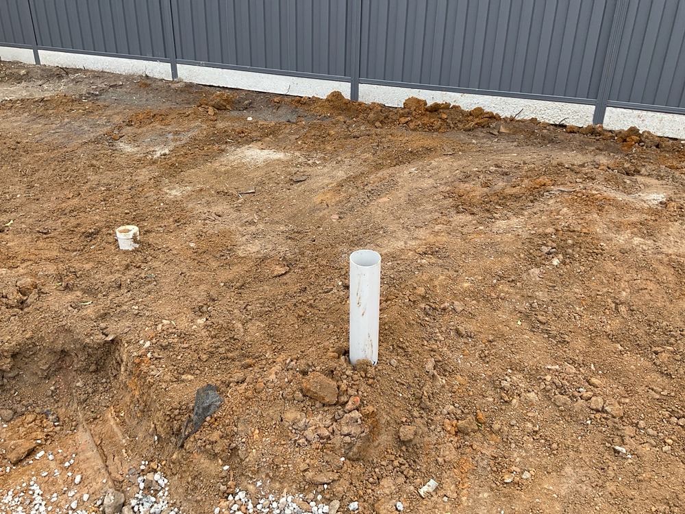 Sewer riser left open, where soil and debris could fall in before the pour, found during a bored pier inspection in Berwick